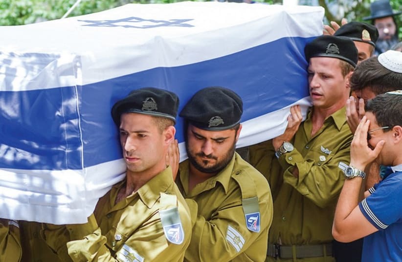 Soldiers carry the coffin of St.-Sgt. Eliav Eliyahu Haim Kahlon during his funeral at the Safed Military Cemetery. (photo credit: FLASH 90)