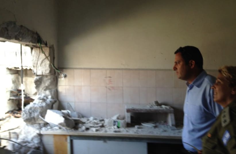 Sderot Mayor Alon Davidi with soldier in damaged building in 2014. (photo credit: Courtesy)
