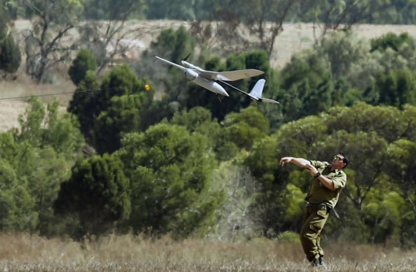 An Israeli soldier launches a Skylark unmanned aerial vehicle near the border with Gaza Strip (photo credit: REUTERS)