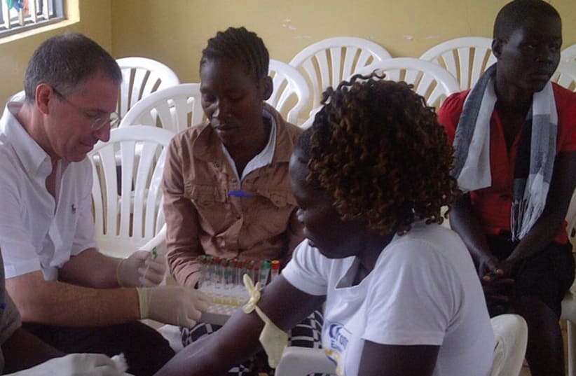 DR. LESLIE LOBEL treats patients in Uganda last year. (photo credit: Courtesy)