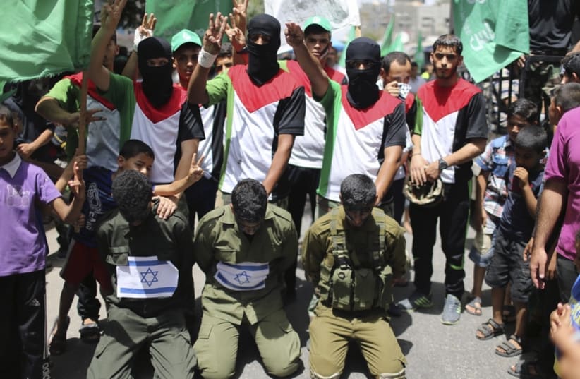 Hamas supporters reenact kidnapping of Israeli soldiers (photo credit: REUTERS)