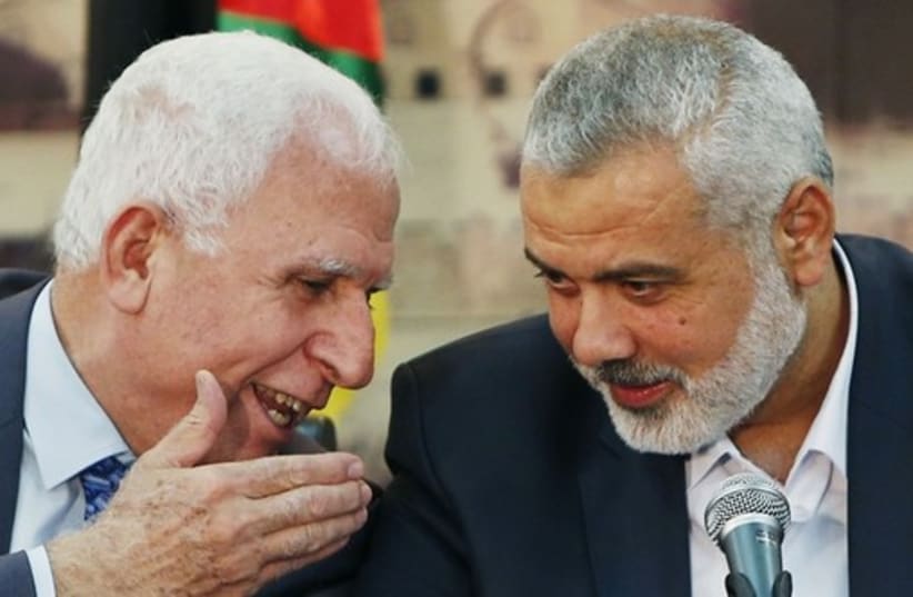 Fatah official Azzam al-Ahmad (L) and Hamas leader Ismail Haniyeh. (photo credit: REUTERS)