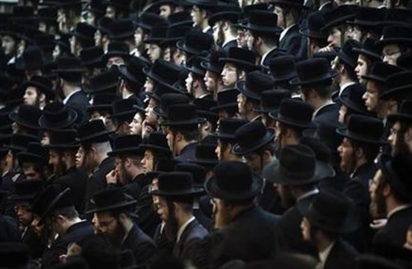 Ultra-Orthodox man take part in a rally in Bnei Brak. (photo credit: REUTERS)