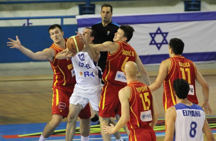 After a bruising defeat to Montenegro, Israel guard Yotam Halperin (center) and his teammates will be aiming to bounce back in their second EuroBasket 2015 qualifier against the Netherlands in Groningen tonight. (photo credit: ISRAEL BASKETBALL ASSOCIATION)
