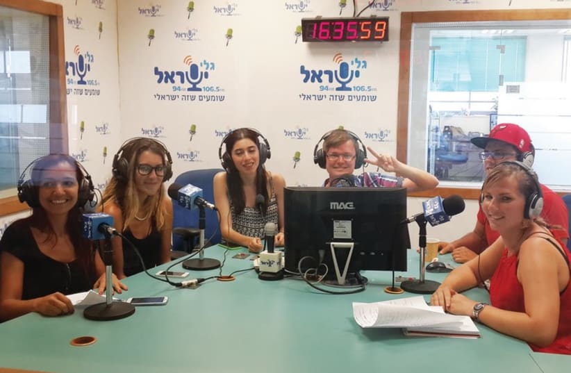 Journalism students pose for a photo at the offices of Galei Israel radio station. (photo credit: TAZPIT)