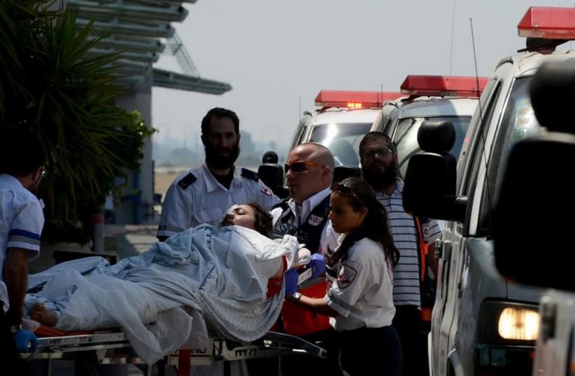 MDA crews evacuate wounded Palestinian from Gaza to Ben-Gurion Airoport for medical evacuation to Turkey.  (photo credit: KOBI GIDEON/GPO)