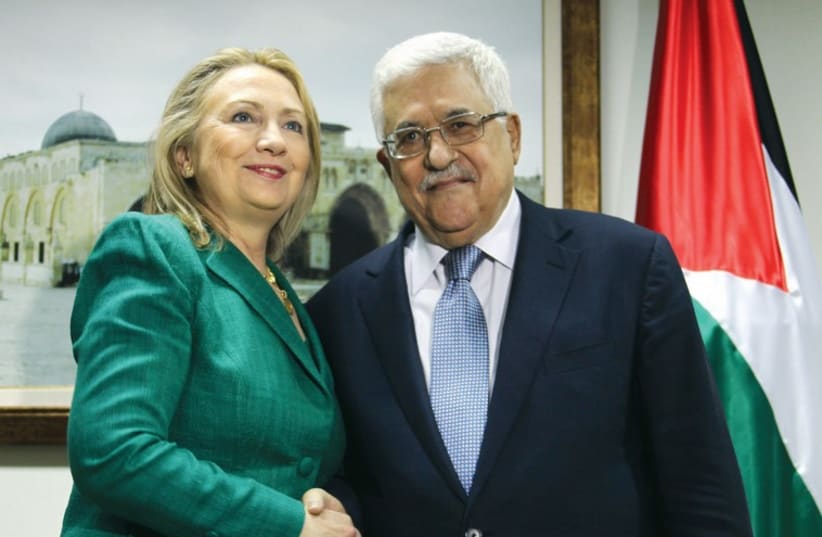Hillary Clinton shakes hands with Palestinian Authority President Mahmoud Abbas in Ramallah in November 2012. (photo credit: REUTERS)
