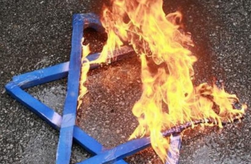 A Star of David burns in flames. (photo credit: REUTERS)