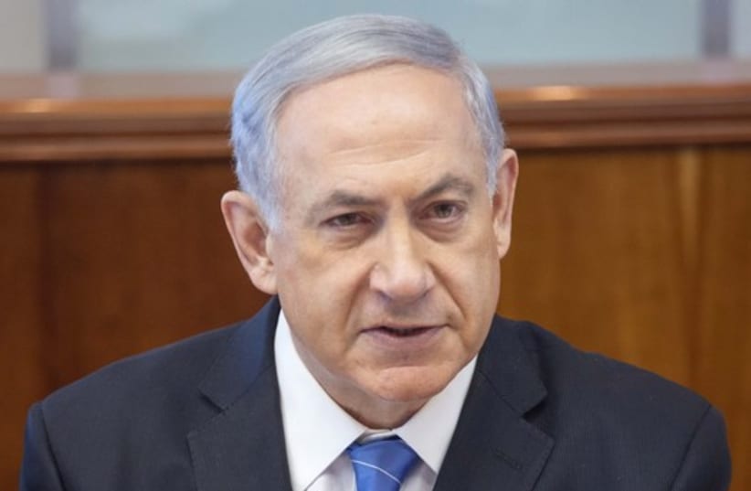 Netanyahu at cabinet meeting (photo credit: EMIL SALMAN/POOL)