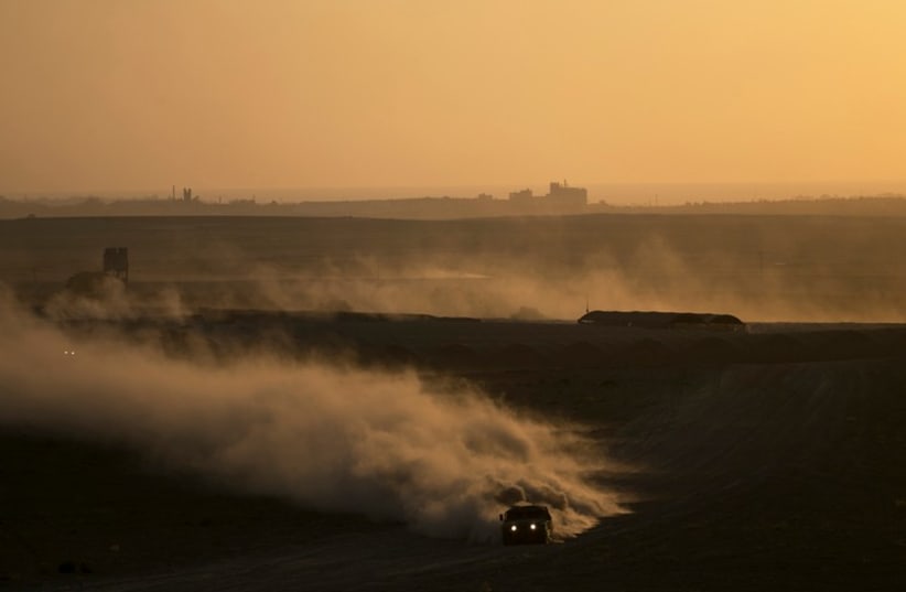 An Israeli Army jeep drives near the border with the Gaza Strip August 20 (photo credit: REUTERS)