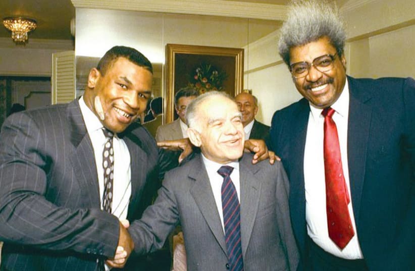 Mike Tyson (left), prime minister Yitzhak Shamir and boxing promoter Don King pose for a rare photo opportunity, organized by then-chief diplomatic adviser Arye Mekel. (photo credit: FACEBOOK)