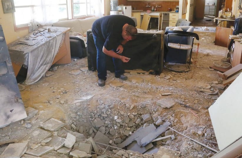 A MORTAR SHELL created this crater in the middle of an alternative medicine center in the Eshkol regional council. (photo credit: MARC ISRAEL SELLEM)