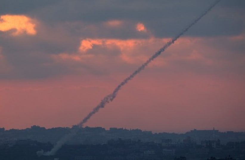 Smoke trails are seen as rockets are launched from the Gaza Strip towards Israel. (photo credit: REUTERS)