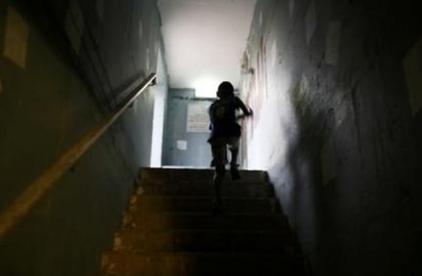 An Israeli boy runs up the stairs in a public bomb shelter. (photo credit: REUTERS)