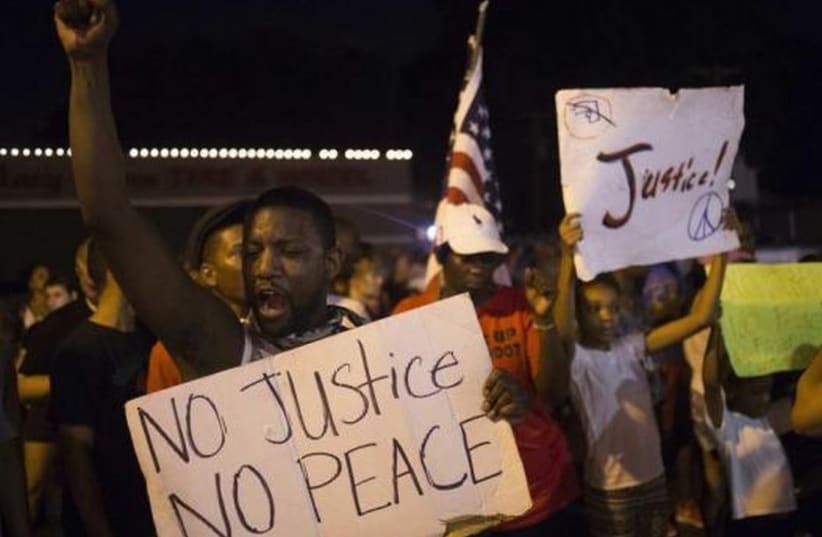 Demonstrators protest against police shooting of black teen in Ferguson, Missouri. (photo credit: REUTERS)