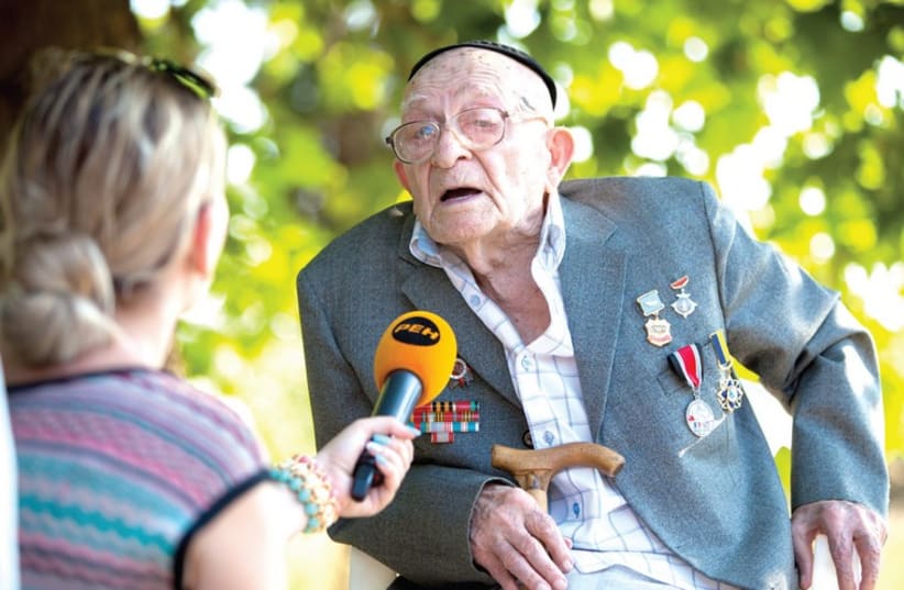 David Osherovich Barulya, a 102-year-old resident of Sevastopol, is interviewed at a memorial service held July 10 in the Crimean city. (photo credit: COURTESY FEDERATION OF JEWISH COMMUNITIES OF RUSSIA)