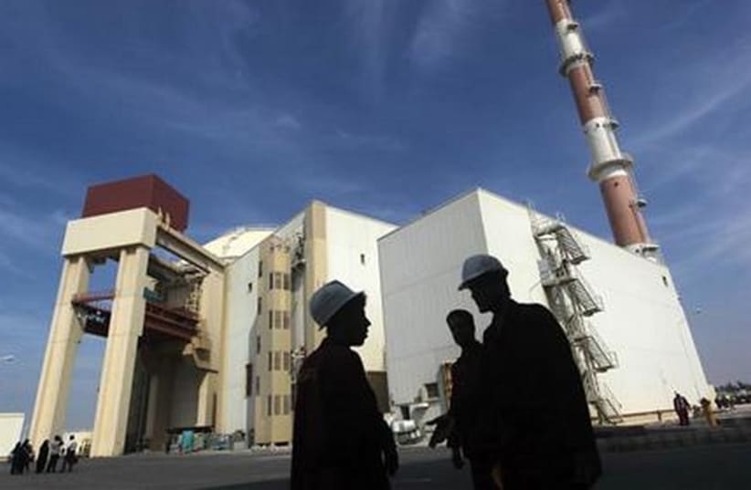 Iranian workers stand in front of the Bushehr nuclear power plant. (photo credit: REUTERS)