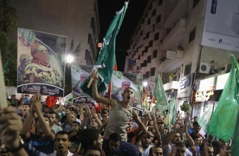 Palestinians in Gaza celebrate cease-fire (photo credit: REUTERS)
