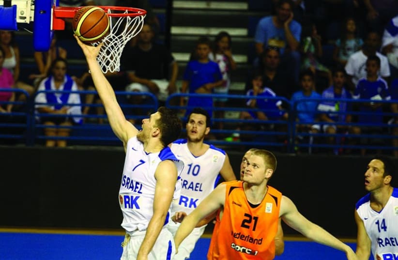 Israel's Gal Mekel scores two points in the EuroBasket competition. (photo credit: ISRAEL BASKETBALL ASSOCIATION)
