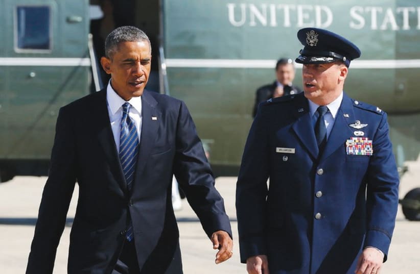US PRESIDENT Barack Obama, accompanied by US Air Force Col. Preston Williamson IV, prepares to depart Andrews Air Force Base outside Washington. (photo credit: REUTERS)