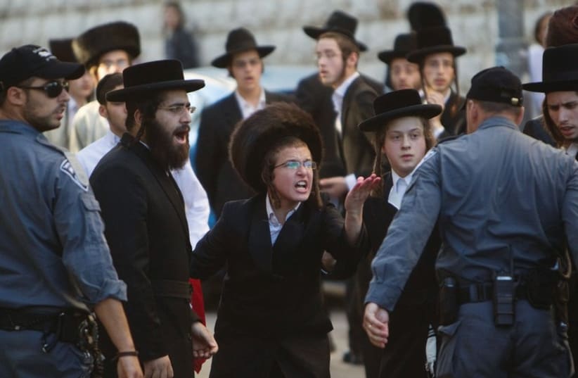 Haredim take part in a protest in Mea She’arim against the municipality opening a nearby road on Shabbat. (photo credit: REUTERS/BAZ RATNER)