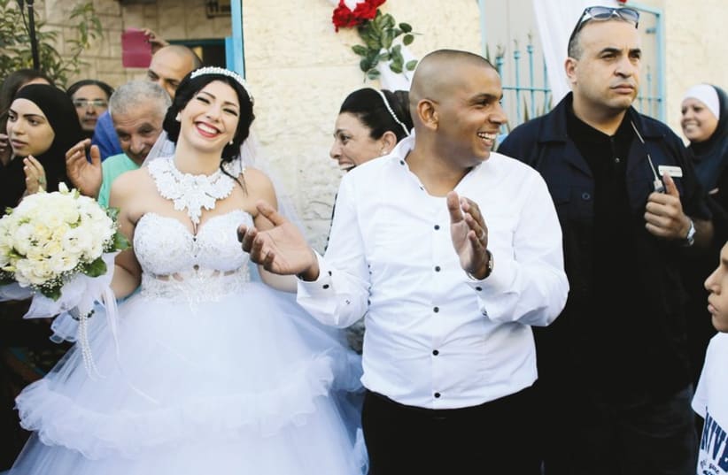 Bride Morel Malka, 23 and her groom Mahmoud Mansour, 26, celebrate with friends and family before their wedding on August 17. (photo credit: REUTERS)