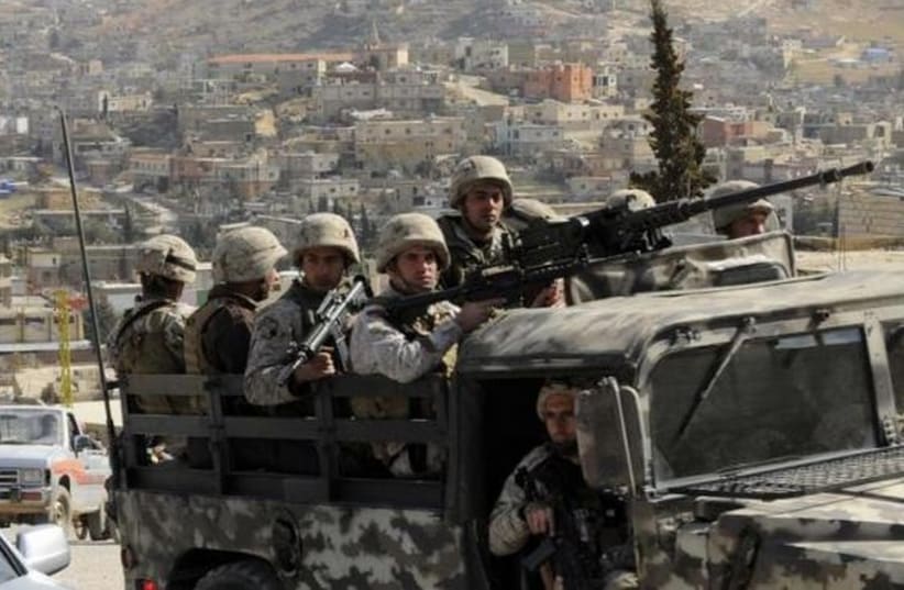 Lebanese army soldiers patrol on their armoured vehicle the Sunni Muslim border town of Arsal. (photo credit: REUTERS)
