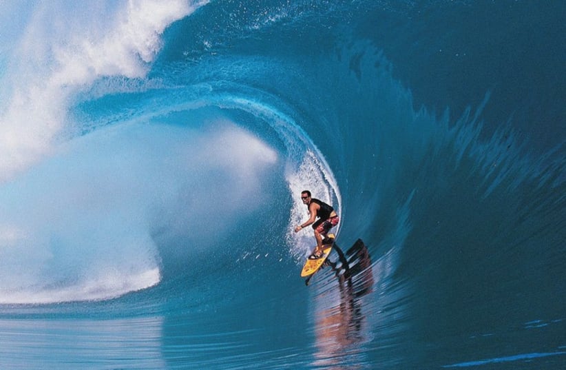 MAKING WAVES: American big-wave surfer Laird Hamilton in a scene from ‘Riding Giants.’ (photo credit: COLLIDER.COM)