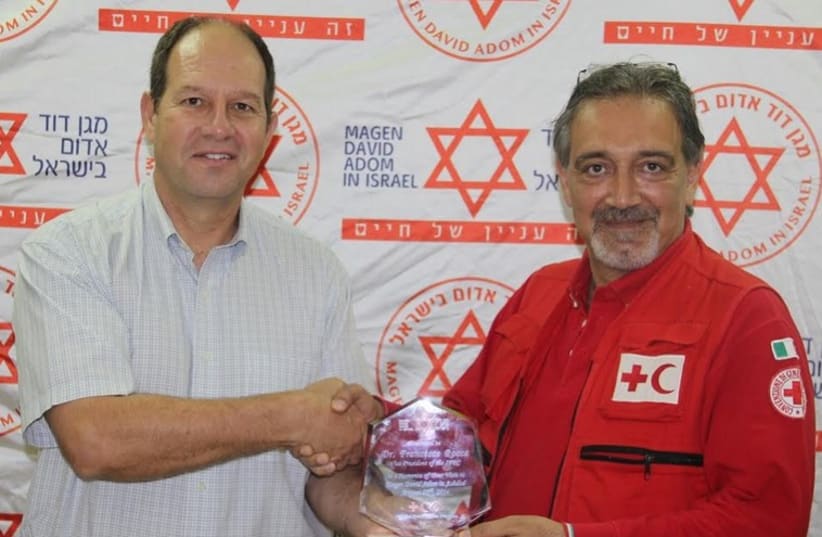 The vice president of the International Federation of Red Cross and Red Crescent Societies, Francesco Rocca (L), receives an award. (photo credit: Courtesy)