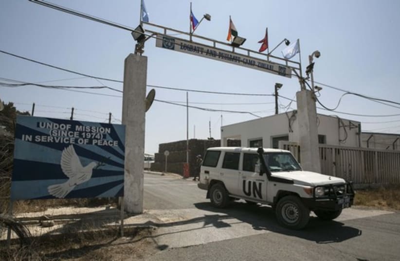 A UN vehicle leaves a UN base in the Golan Heights. (photo credit: REUTERS)