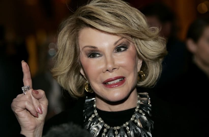 Comedian Joan Rivers talks to reporters as she arrives for a gala honoring the late stand-up comedian George Carlin. (photo credit: REUTERS)