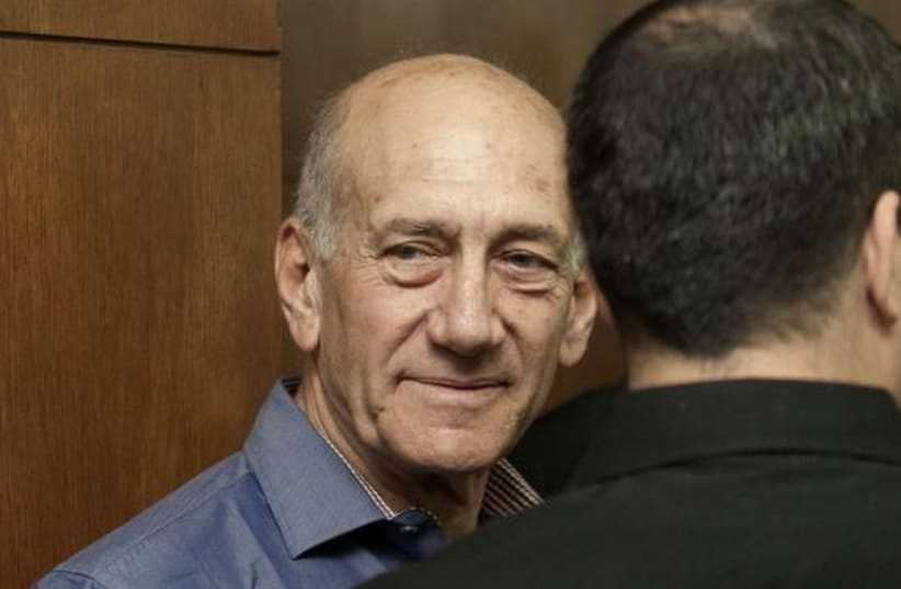 Former Israeli Prime Minister Ehud Olmert waits to hear his verdict at the Tel Aviv District Court, March 31, 2014. (photo credit: REUTERS)