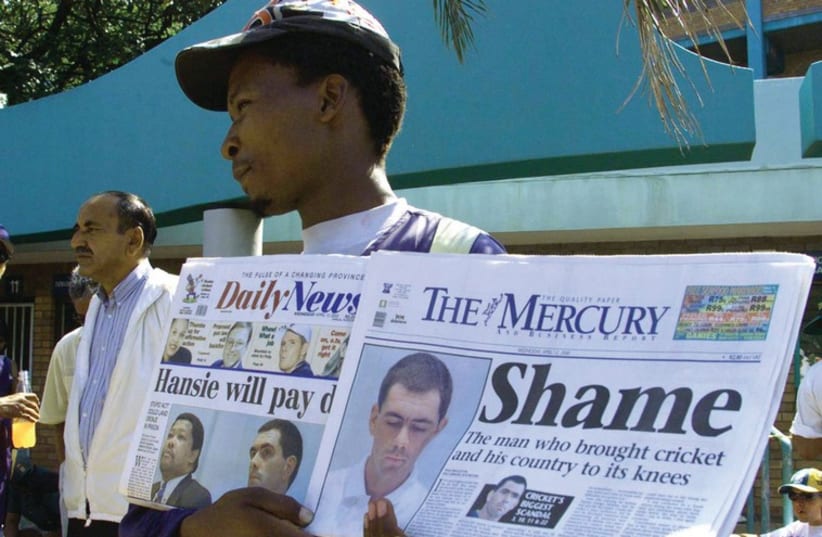 A VENDOR sells newspapers in South Africa.  (photo credit: REUTERS)