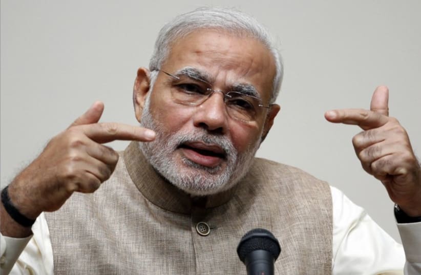 India's Prime Minister Narendra Modi gestures as he gives a speech in front of students at the University of the Sacred Heart in Tokyo. (photo credit: REUTERS)