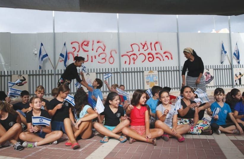 ‘The separation wall is a disgrace to Zionism’ is written on the structure in the Beit Shemesh school yard. (photo credit: NATI SHOHAT / FLASH 90)