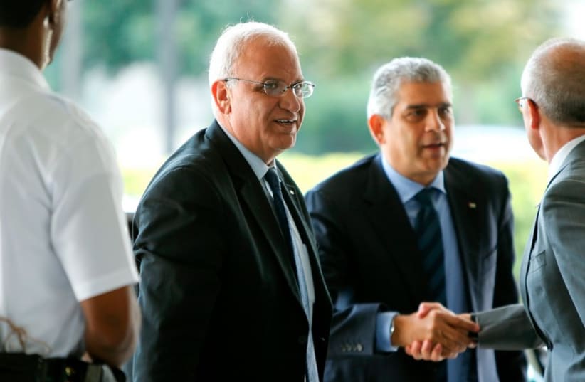 Palestinian Chief Negotiator Saeb Erekat (C) and Maen Rashid Areikat (2nd R), chief of the PLO)delegation in Washington, arrive to meet with US Secretary of State John Kerry in Washington September 3, 2014. (photo credit: REUTERS)