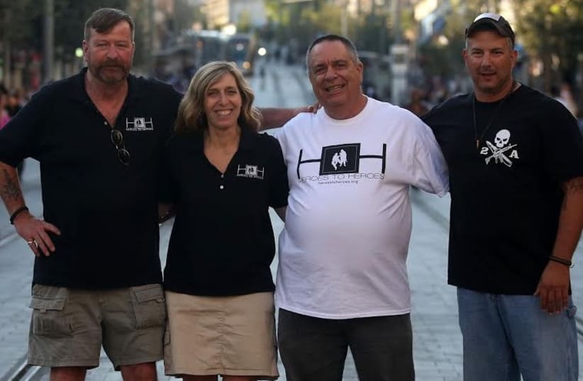 HEROES TO HEROES founder Judy I. Schaffer poses with (from left) US military veteran Cliff Nolan, IDF veteran Zvika Comay, and US veteran Gregory Cruz, in Jerusalem (photo credit: MARC ISRAEL SELLEM/THE JERUSALEM POST)