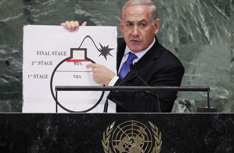 Prime Minister Binyamin Netanyahu points to a diagram of a bomb at the UN. (photo credit: REUTERS)
