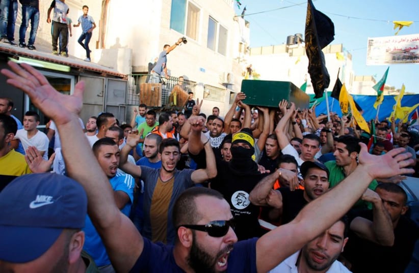 Palestinians carry the coffin of Muhammad Sunuqrut during his funeral in East Jerusalem's Wadi Joz neighbourhood, September 8 (photo credit: REUTERS)