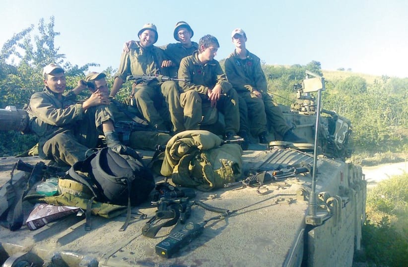 Avraham Itzhak Mendelevich (inset) and on a tank with his fellow soldiers. (photo credit: Courtesy)