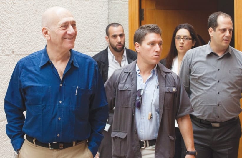 Former prime minister Ehud Olmert arrives at the Supreme Court. (photo credit: EMIL SALMAN/POOL)