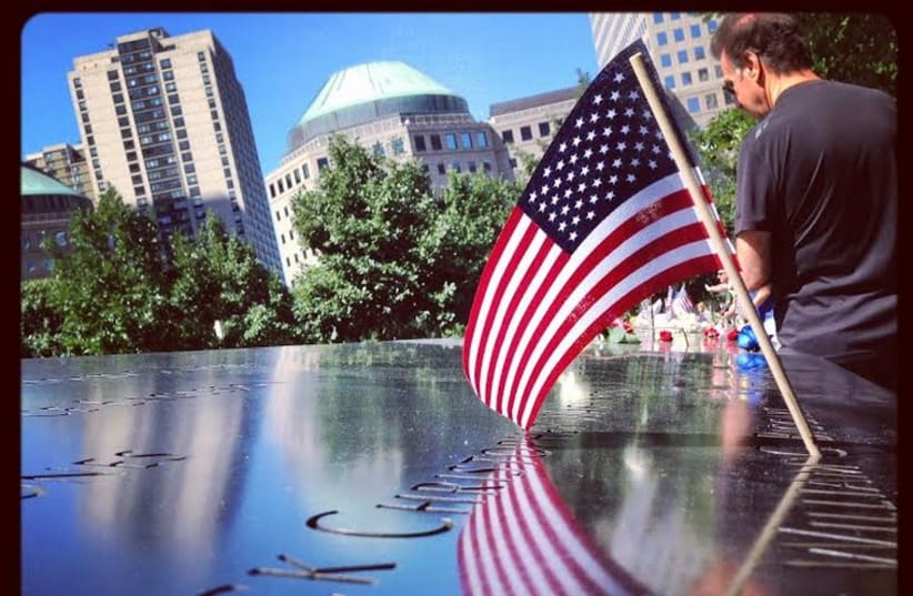 Mourners pay tribute to the victims of the 9/11 terror attacks (photo credit: ANNA HIATT)