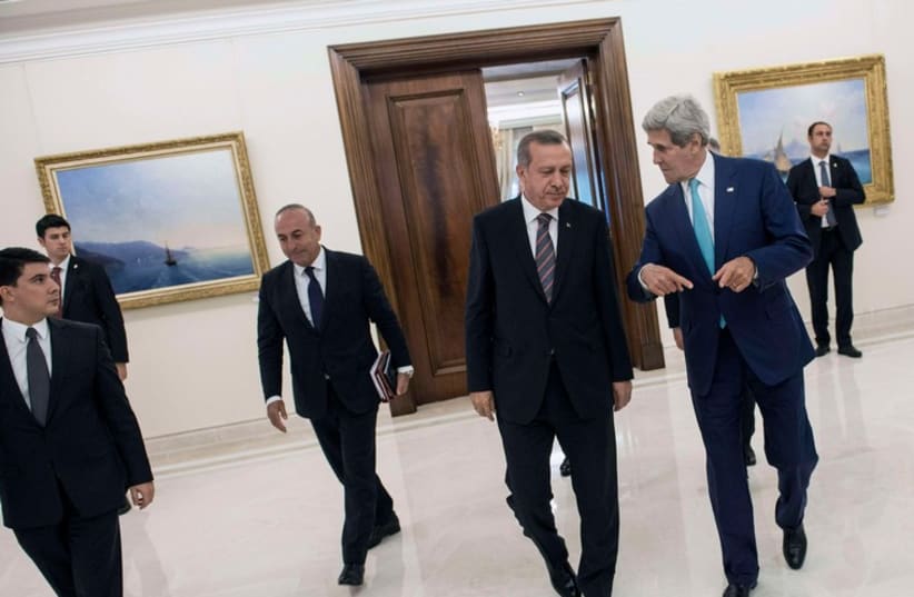 Turkey's President Recep Tayyip Erdogan (C) and US Secretary of State John Kerry (R) leave a meeting in Ankara September 12, 2014.  (photo credit: REUTERS)