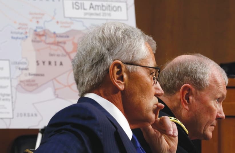 US SECRETARY of Defense Chuck Hagel (left) and Chairman of the Joint Chiefs of Staff Gen. Martin Dempsey testify yesterday during the Senate Armed Services Committee hearing on US policy toward Iraq and Syria. (photo credit: REUTERS)