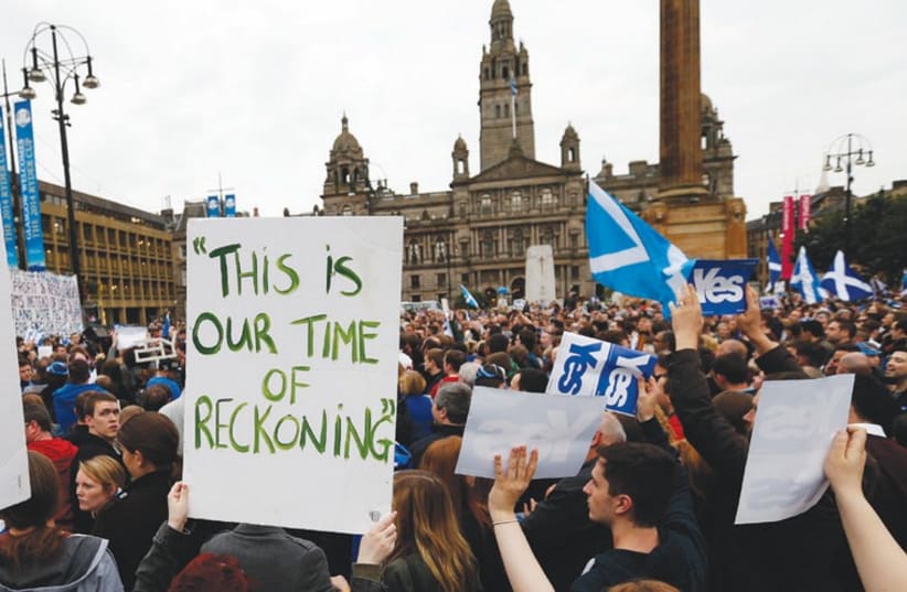 ‘YES’ SUPPORTERS congregate at George Square in Glasgow. (photo credit: REUTERS)