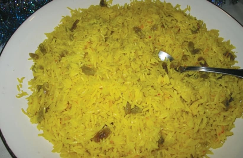 Yellow basmati rice mixes a savory taste with a sweet one by adding green raisins. (photo credit: YAKIR LEVY)