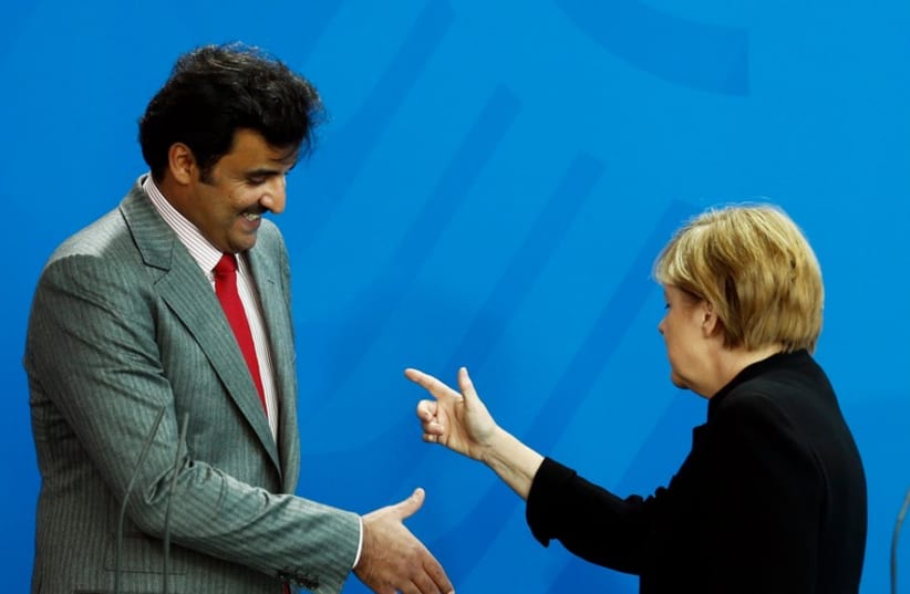 Qatar's ruler, Emir Sheikh Tamim bin Hamad al-Thani, reaches out to German Chancellor Angela Merkel September 17 in Berlin (photo credit: REUTERS)