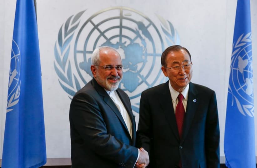 United Nations Secretary General Ban Ki-moon shakes hands with Iranian Foreign Minister Mohammad Javad Zarif at UN headquarters in New York, September 18 (photo credit: REUTERS)