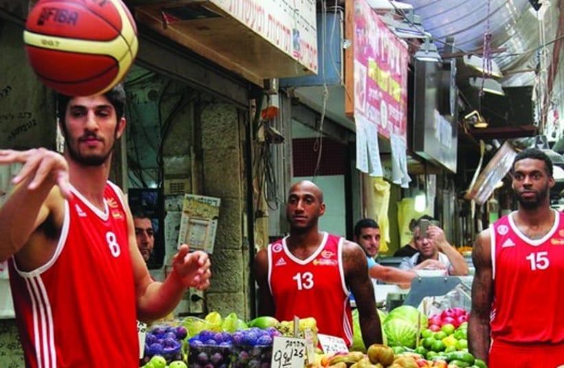 Hapoel Jerusalem basketball players visit the Mahane Yehuda open-air market. (photo credit: OREN BEN HAKON)