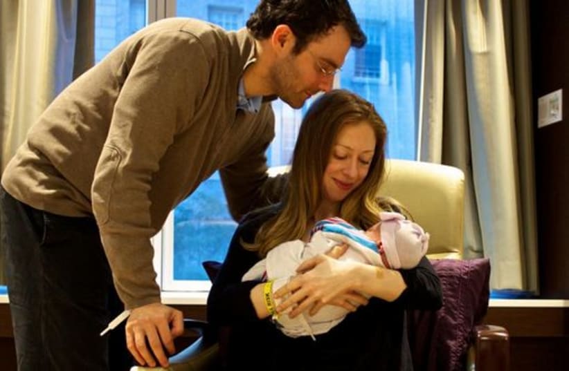 Chelsea Clinton with her new born baby Charlotte (photo credit: CHELSEA CLINTON'S TWITTER ACCOUNT)